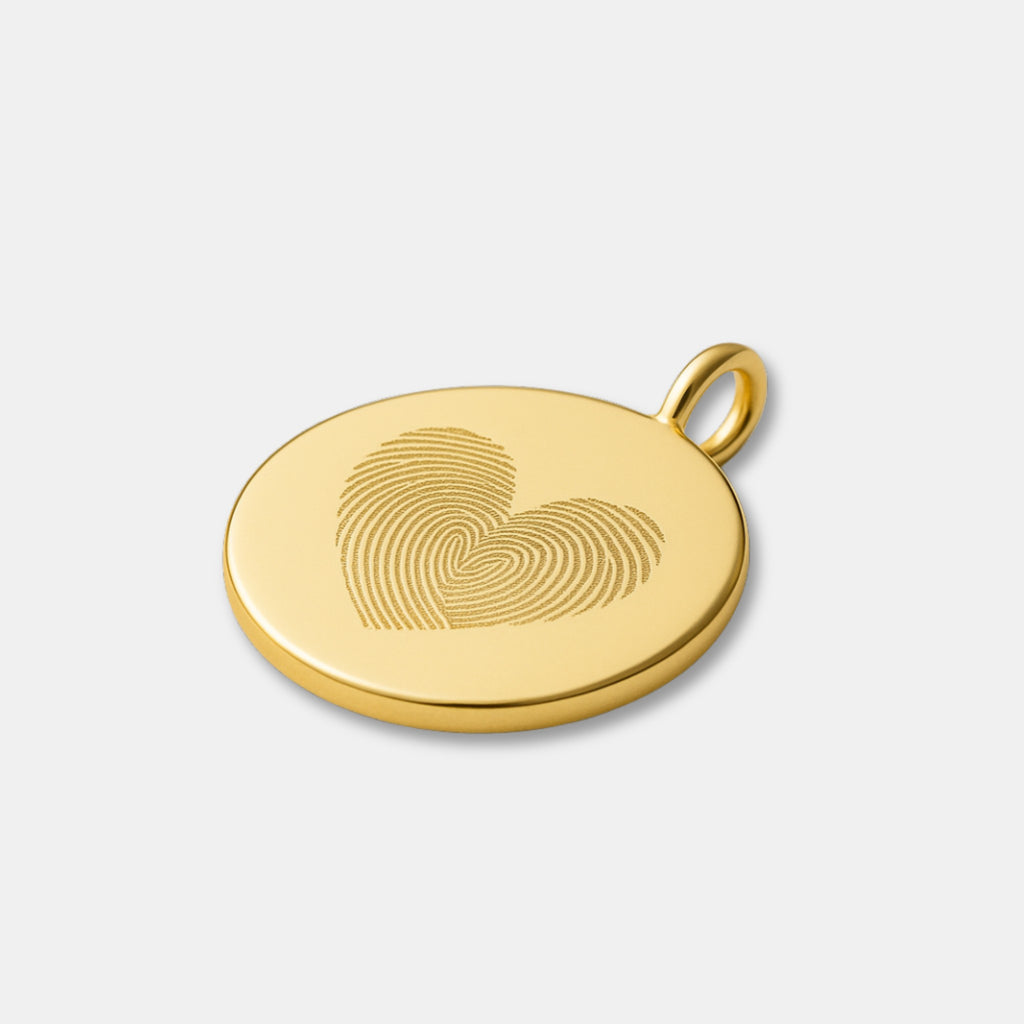 Flat lay of the Heart Fingerprint Pendant in 18K Gold Vermeil by Atelier. Features two fingerprints intricately engraved to form a heart shape, representing love and unity. A luxurious personalised keepsake crafted from high-quality gold vermeil with a smooth, polished finish.