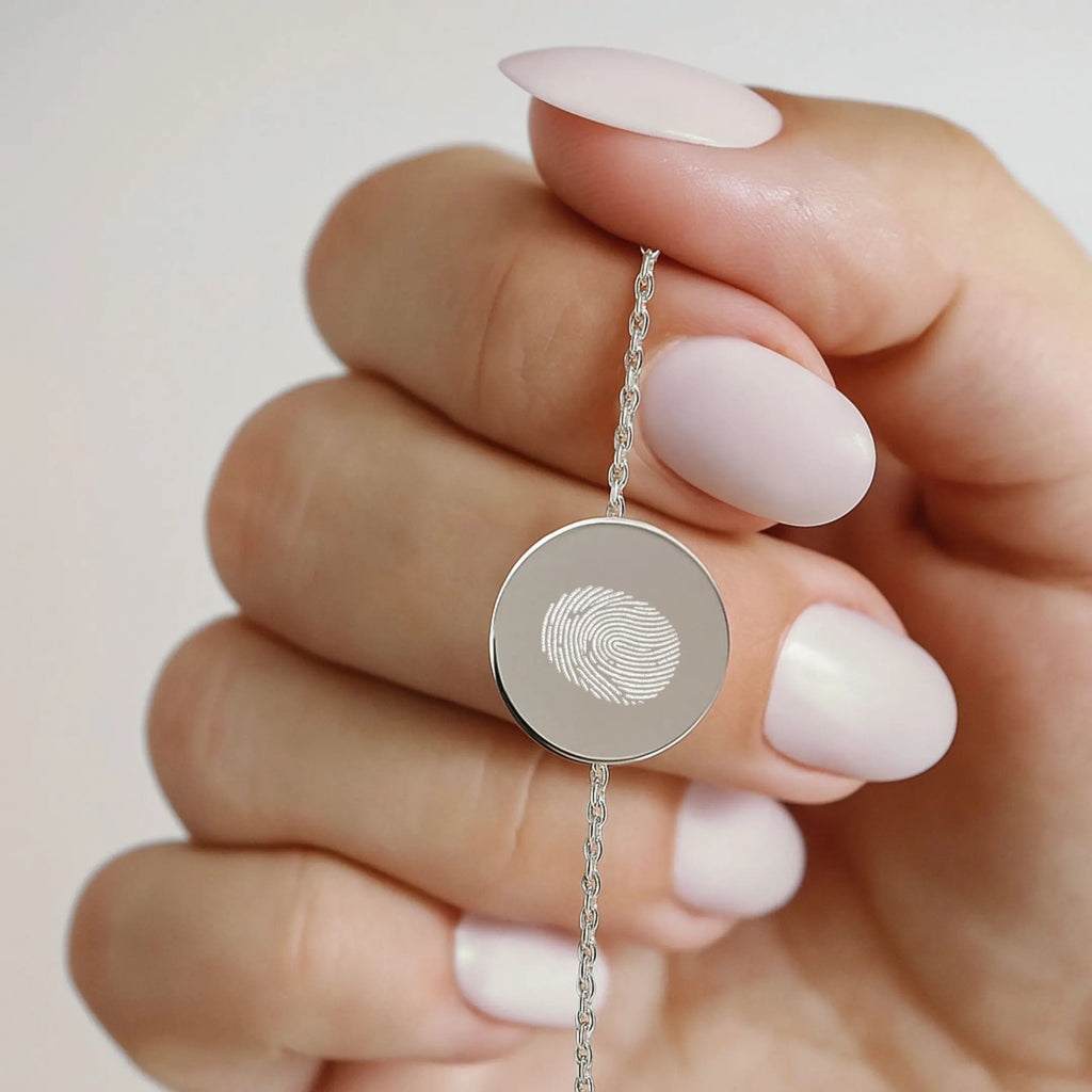 Close-up of Atelier By DSGN single fingerprint coin bracelet in 925 sterling silver, showcasing intricate design and texture.