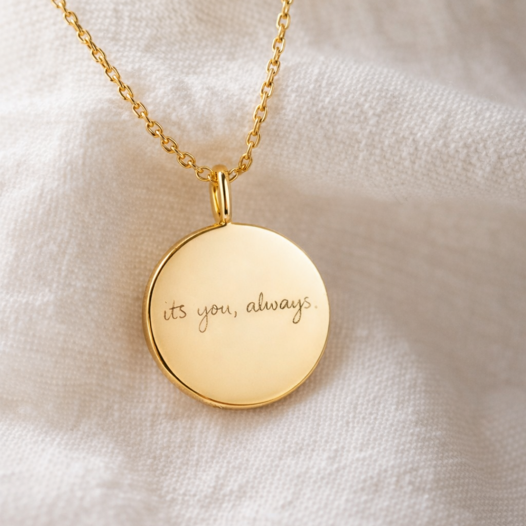 Custom engraved 18k gold vermeil 16mm coin pendant necklace laid on soft white fabric, personalised handwritten message "its you, always" faithfully diamond-head precision engraved on warm high-polish gold disc on delicate gold cable chain – Atelier By Dsgn luxury personalised handwriting jewellery elegant gift for her, bride, anniversary, valentines day or cherished heirloom keepsake necklace