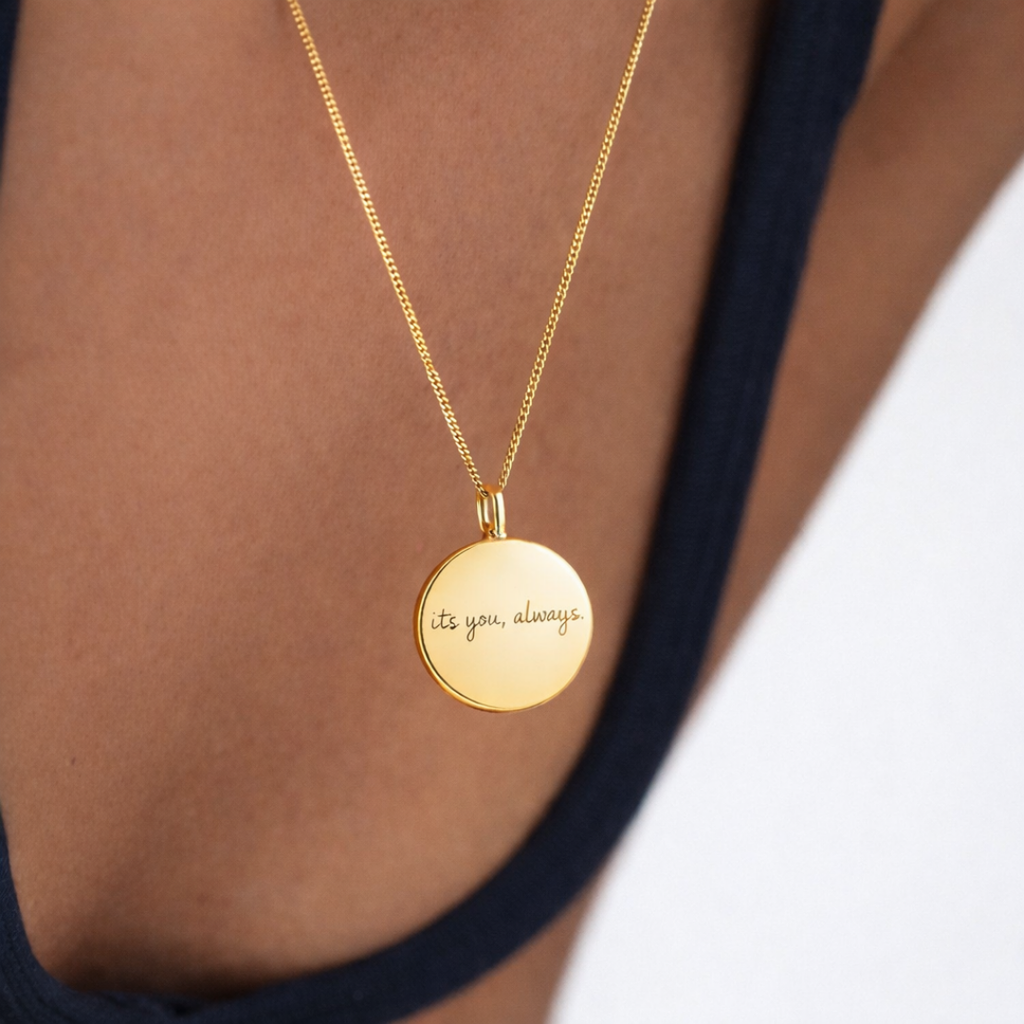 Custom engraved 18k gold vermeil 16mm coin pendant necklace worn on female model at collarbone in navy top, personalised handwritten message "its you, always" precision diamond-head engraved on warm lustrous gold disc suspended on fine gold curb chain – Atelier By Dsgn luxury personalised handwriting jewellery everyday wear gift for her, anniversary, birthday or meaningful sentimental keepsake necklace