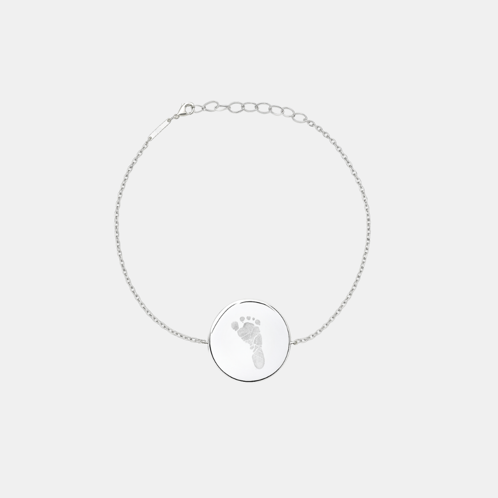 Custom engraved 925 sterling silver adjustable coin bracelet, featuring a personalised single newborn baby footprint with intricate toe and sole detail precision diamond-head engraved on polished round disc on delicate diamond-cut cable chain – Atelier By Dsgn custom footprint coin bracelet meaningful gift for new mum, mothers day, baby shower, new baby arrival or treasured newborn family keepsake bracelet