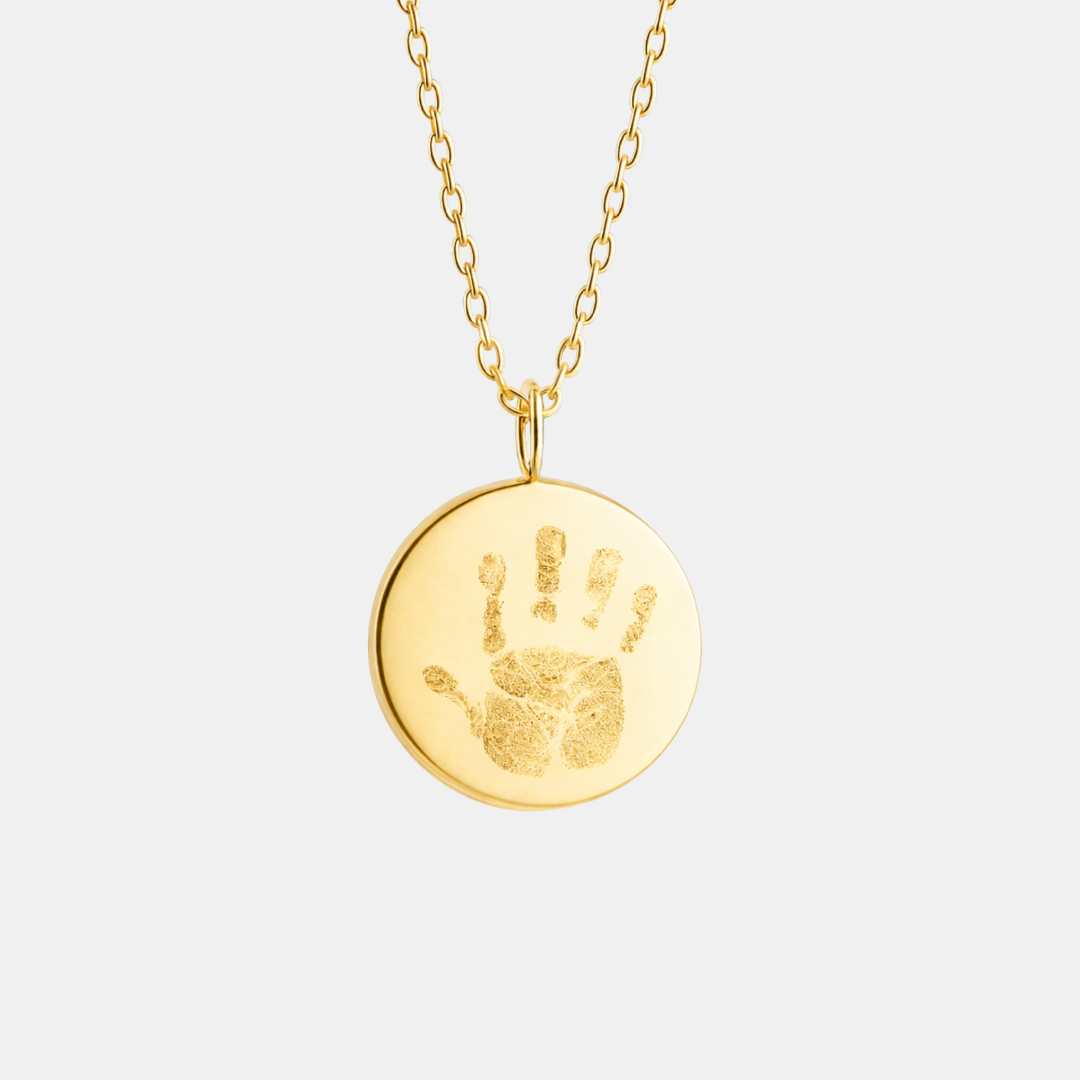 Custom engraved 18k gold vermeil 16mm coin pendant necklace on diamond-cut cable chain, featuring a personalised baby handprint with intricate finger and palm detail precision diamond-head engraved on warm high-polish gold disc – Atelier By Dsgn luxury custom handprint coin necklace meaningful gift for new mum, new dad, mothers day, fathers day, baby shower, new baby arrival or treasured newborn family heirloom necklace