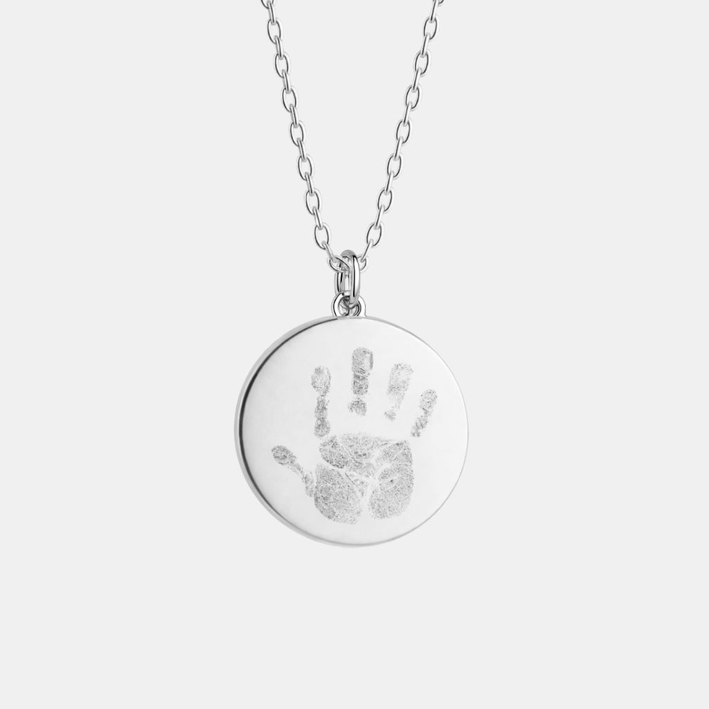 Custom engraved 925 sterling silver 16mm coin pendant necklace on diamond-cut cable chain, featuring a personalised baby handprint with intricate finger and palm detail precision diamond-head engraved on polished round disc – Atelier By Dsgn custom handprint pendant jewellery meaningful gift for new mum, new dad, mothers day, fathers day, new baby arrival, child memorial or treasured family keepsake necklace