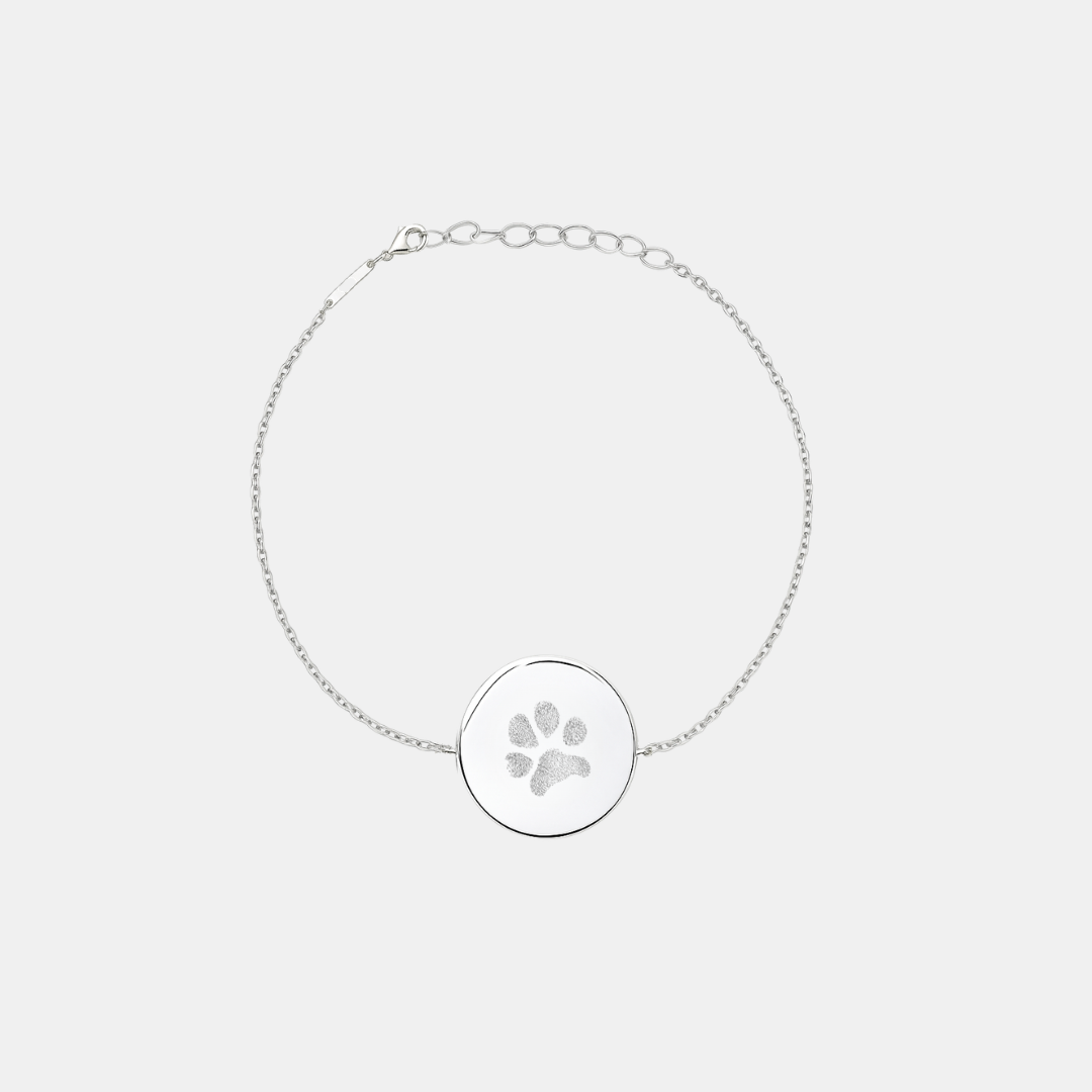Custom engraved 925 sterling silver adjustable coin bracelet, featuring a personalised pet paw print with intricate toe and pad texture detail precision diamond-head engraved on polished round disc on delicate diamond-cut cable chain – Atelier By Dsgn custom paw print coin bracelet meaningful gift for dog lovers, cat lovers, pet mum, pet dad, pet memorial, rainbow bridge remembrance or new pet adoption keepsake bracelet