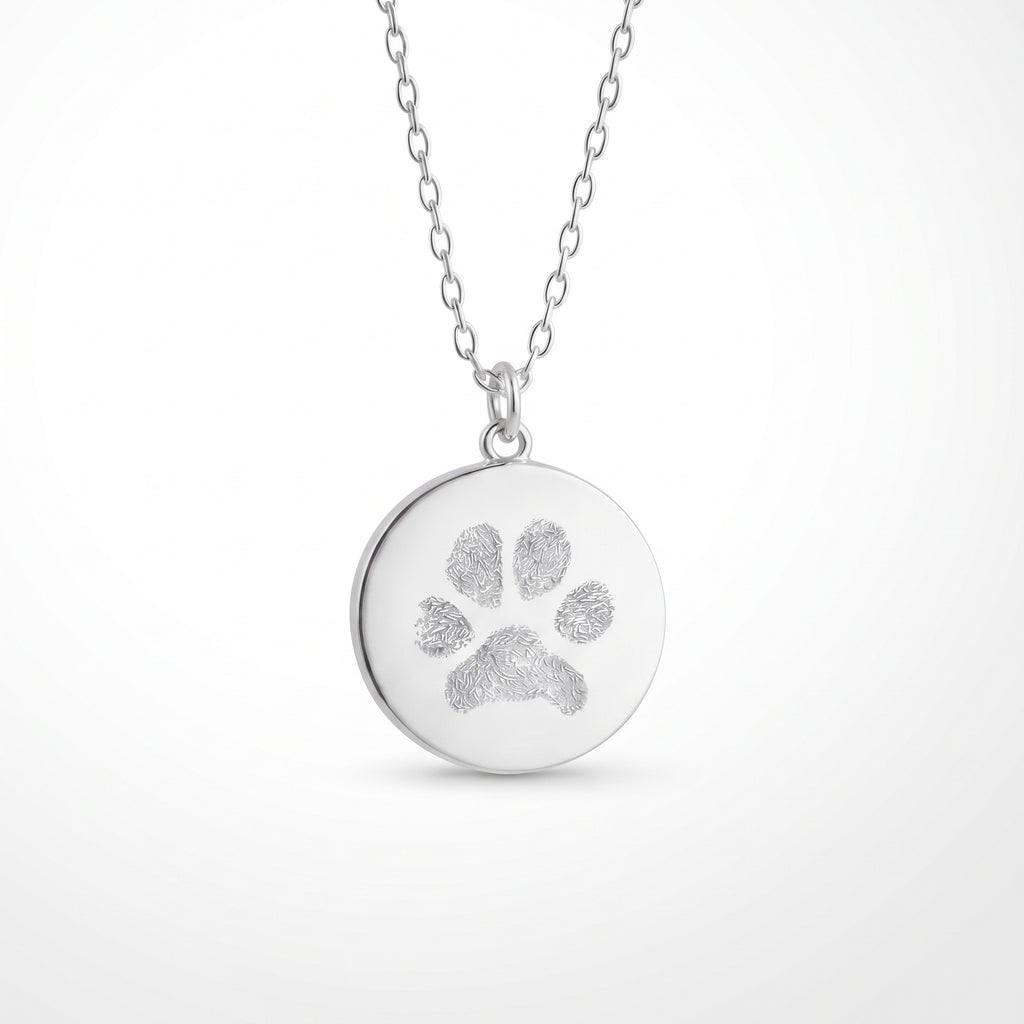 Custom engraved 925 sterling silver 16mm coin pendant necklace on diamond-cut cable chain, featuring a personalised pet paw print with intricate toe and pad texture detail precision diamond-head engraved on polished round disc.  Atelier By Dsgn custom paw print pendant jewellery meaningful gift for dog lovers, cat lovers, pet mum, pet dad, pet memorial, rainbow bridge remembrance or new pet adoption keepsake necklace.  Atelier By DSGN