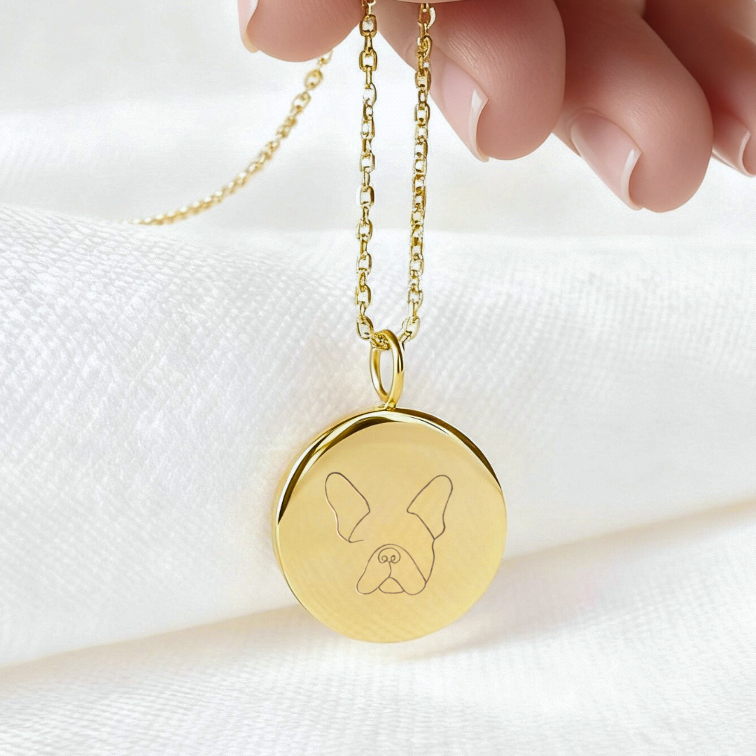 Custom engraved 18k gold vermeil 16mm single-line drawing coin pendant necklace against a white background,  personalised minimalist French Bulldog face portrait with signature bat ears precision diamond-head engraved on warm lustrous gold disc on delicate diamond-cut cable chain – Atelier By Dsgn luxury custom pet portrait jewellery everyday wear gift for dog lovers, French Bulldog mum, pet memorial or new puppy celebration keepsake necklace