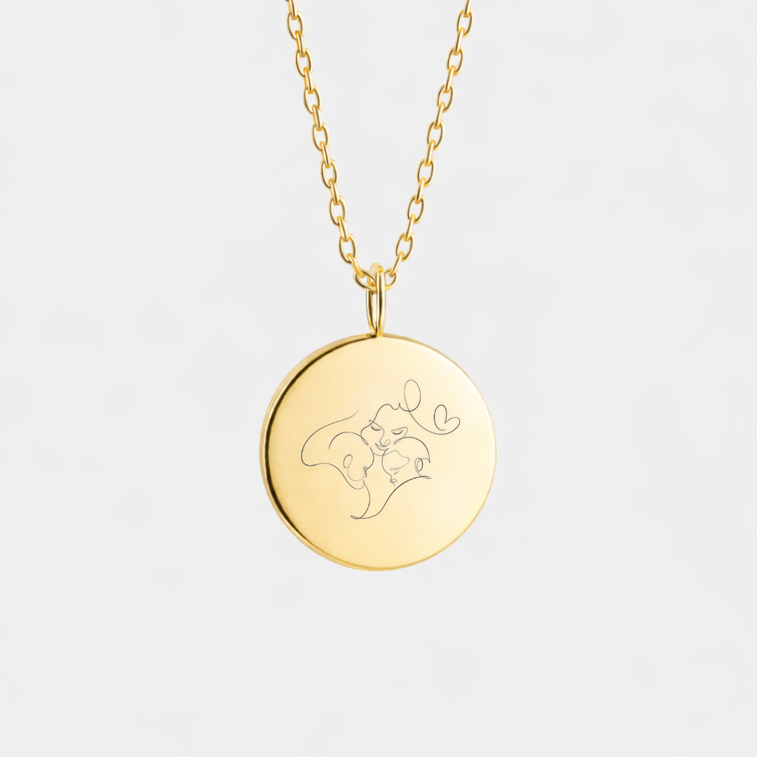 Custom engraved 18k gold vermeil 16mm coin pendant necklace on diamond-cut cable chain, featuring a delicate personalised single-line minimalist mother and baby portrait with heart detail precision diamond-head engraved on warm polished gold disc – Atelier By Dsgn luxury custom line art portrait jewellery meaningful gift for new mum, mothers day, baby shower, birth keepsake or cherished family heirloom necklace