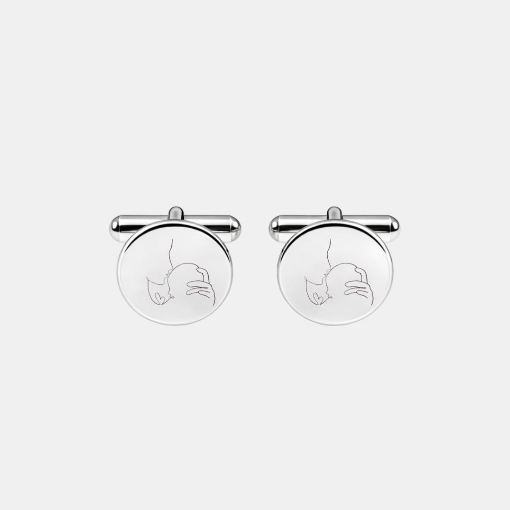 Pair of custom engraved 925 sterling silver round cufflinks featuring personalised single-line minimalist mother cradling newborn baby portrait precision diamond-head engraved on polished silver face – Atelier By Dsgn custom line art portrait cufflinks deeply personal gift for new dad, fathers day, wedding day, groomsmen, new baby arrival or treasured family keepsake mens jewellery