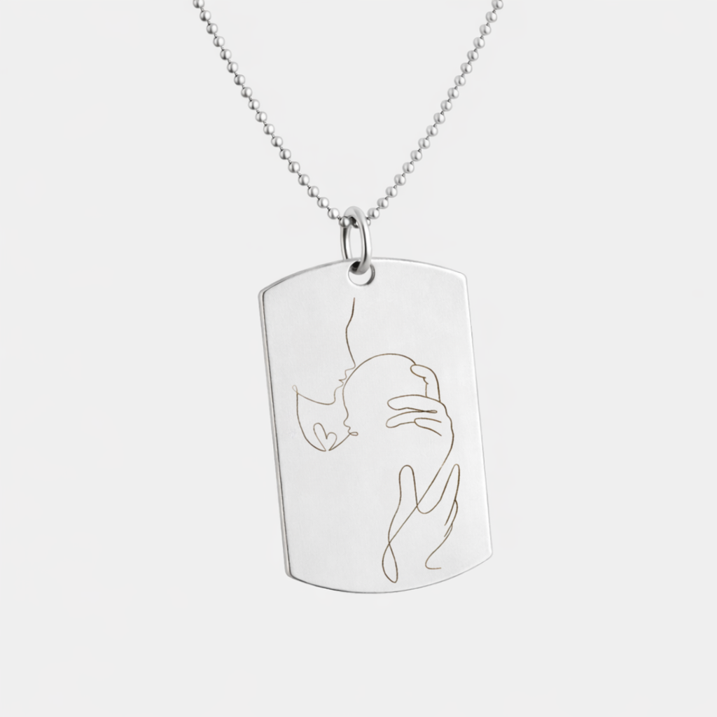 Custom engraved 925 sterling silver dog tag necklace on 61cm bead chain, featuring a personalised single-line minimalist portrait of a mother cradling her newborn baby precision diamond-head engraved on polished silver tag – Atelier By Dsgn custom portrait jewellery deeply personal gift for new mum, mothers day, baby shower, birth keepsake or meaningful family heirloom necklace