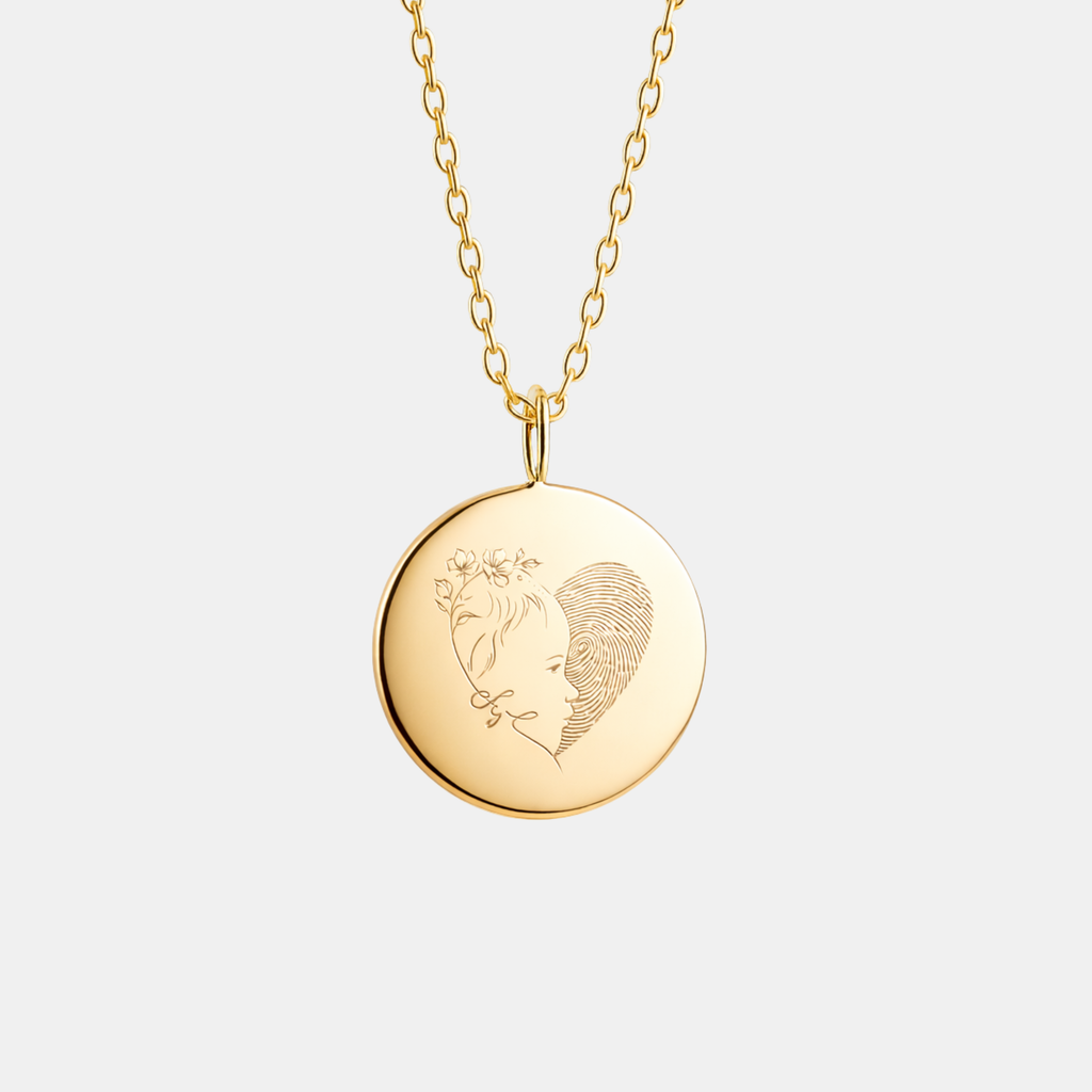 Custom engraved 18k gold vermeil 16mm coin pendant necklace on diamond-cut cable chain, featuring a personalised single-line minimalist female side profile portrait with delicate floral detail uniquely fused with actual fingerprint texture precision diamond-head engraved on warm high-polish gold disc – Atelier By Dsgn luxury custom fingerprint portrait jewellery deeply personal gift for her, mothers day, anniversary, valentines day, birthday or cherished memorial heirloom necklace