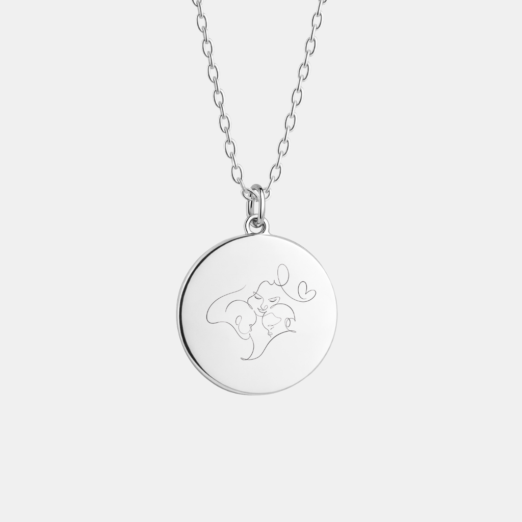 Custom engraved 925 sterling silver 16mm coin pendant necklace on diamond-cut cable chain, featuring a delicate personalised single-line minimalist portrait of a mother and baby with heart detail precision diamond-head engraved on polished round disc – Atelier By Dsgn custom line art portrait jewellery meaningful gift for new mum, mothers day, baby shower, birth keepsake or cherished family heirloom necklace