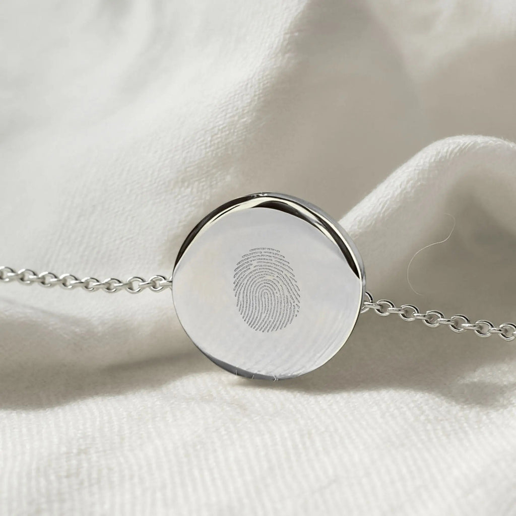 Single fingerprint coin bracelet in 925 sterling silver by Atelier By DSGN showcasing unique engraving detail.