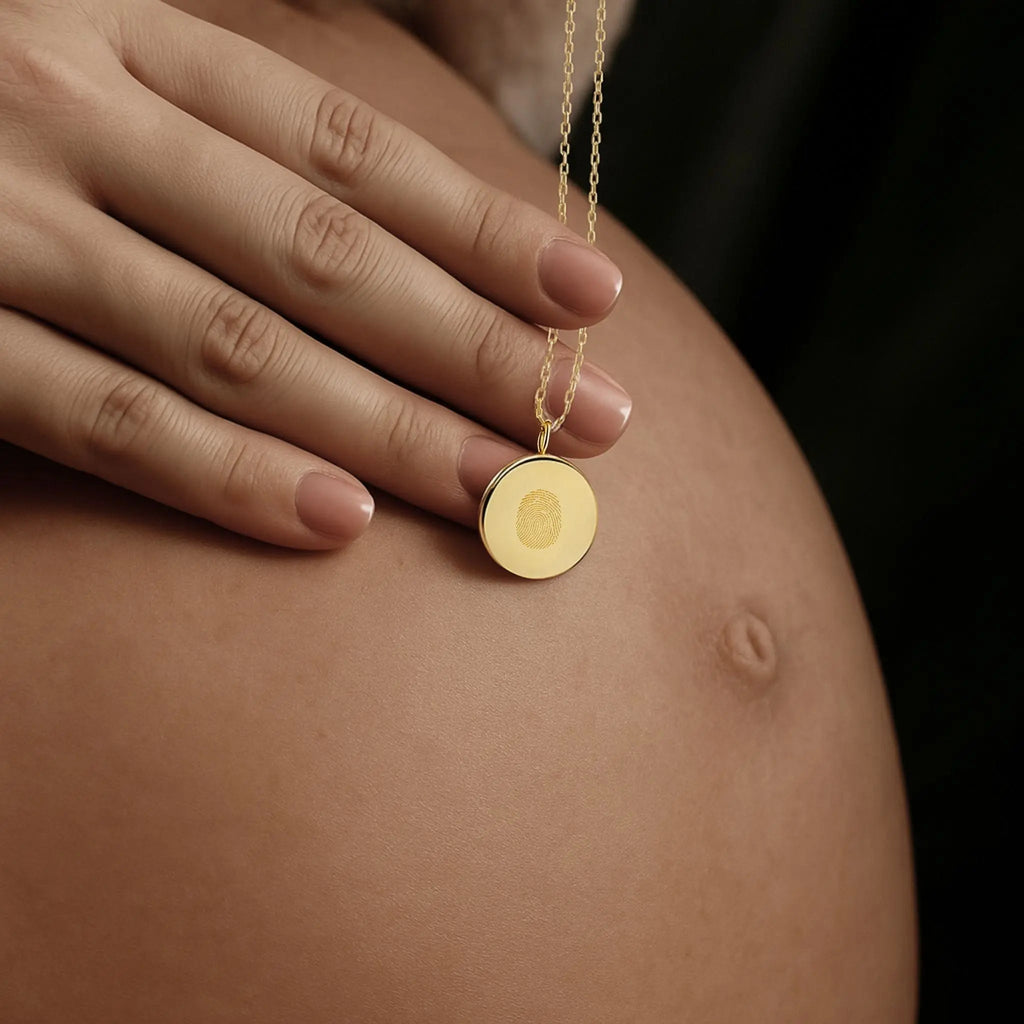 Single fingerprint coin necklace in 18k gold vermeil by Atelier By DSGN  showcasing a delicate design for mother and baby love.