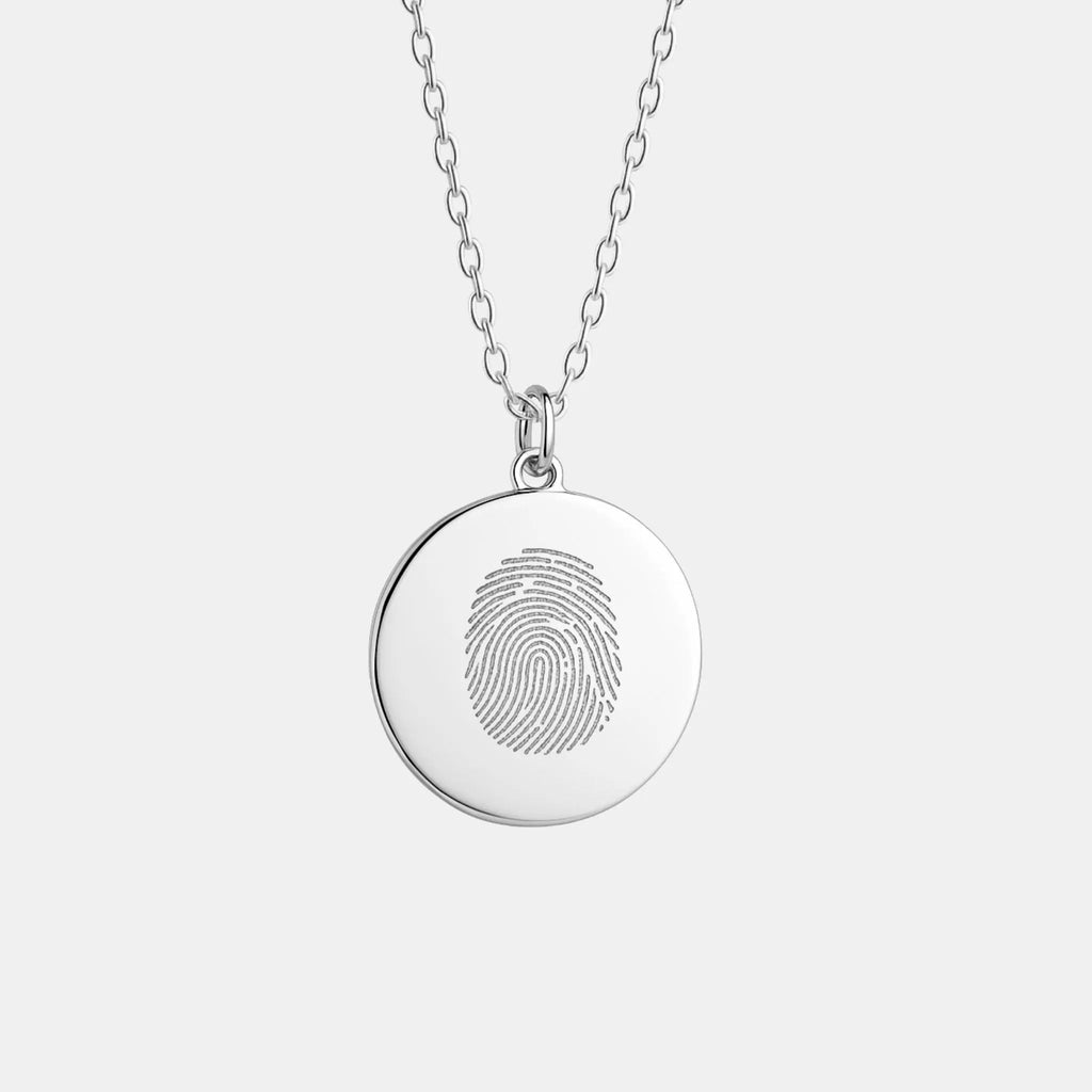 The Atelier By DSGN Single Fingerprint Pendant Necklace in 925 Sterling Silver — a minimalist round coin pendant featuring a finely engraved fingerprint design, symbolising love, memory, and personal connection in elegant handcrafted jewelry.