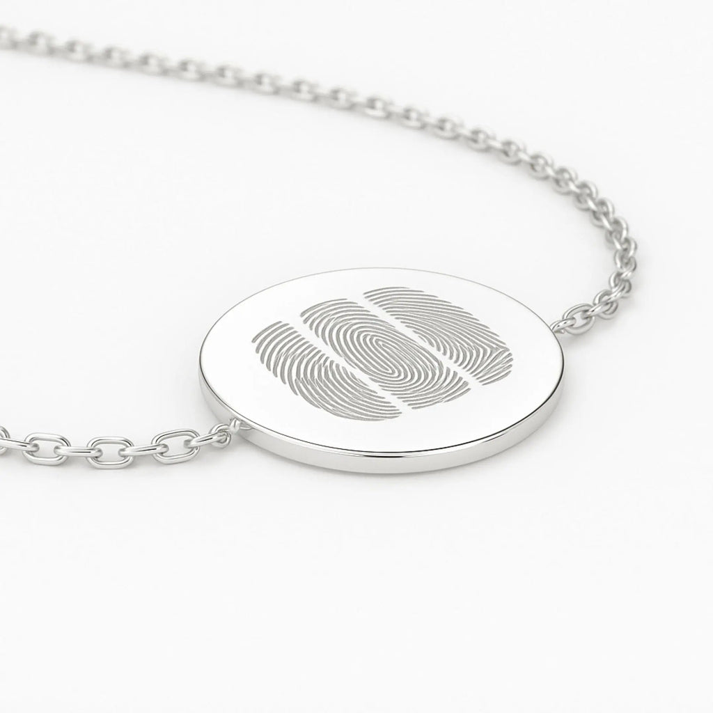 Close-up of Atelier By DSGN three fingerprint coin bracelet in 925 sterling silver, showcasing intricate details and design.