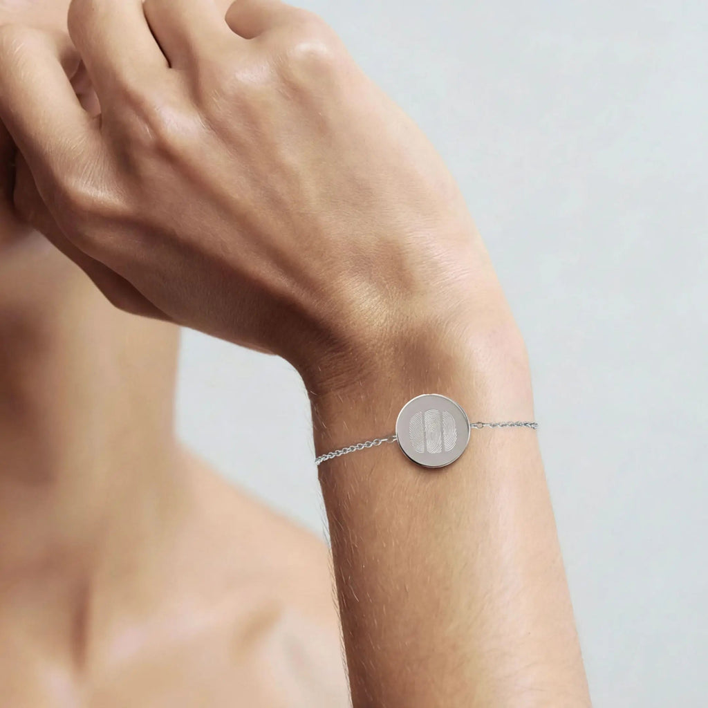 Three fingerprint coin bracelet in 925 sterling silver worn on a wrist, showcasing its elegant design by Atelier By DSGN.