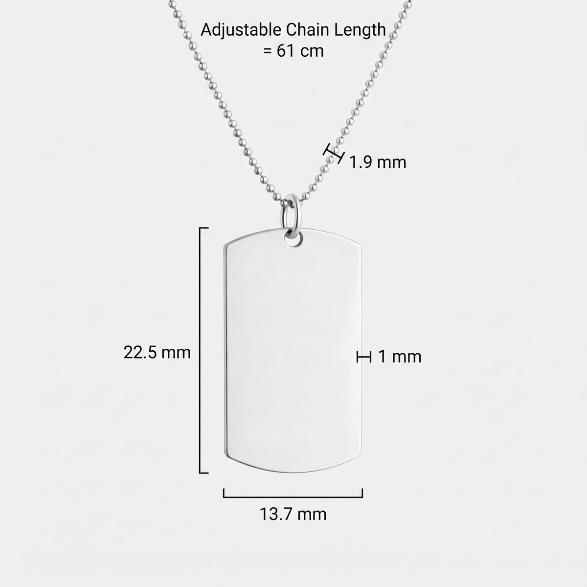 Custom 925 sterling silver dog tag pendant necklace shown on a light gray background with product dimension labels indicating 13.7 mm width, 22.5 mm height, and 1 mm thickness and with an adjustable 61cm ball chain necklace with 19mm balls.  Meaningful engraved jewelry from Atelier By DSGN.