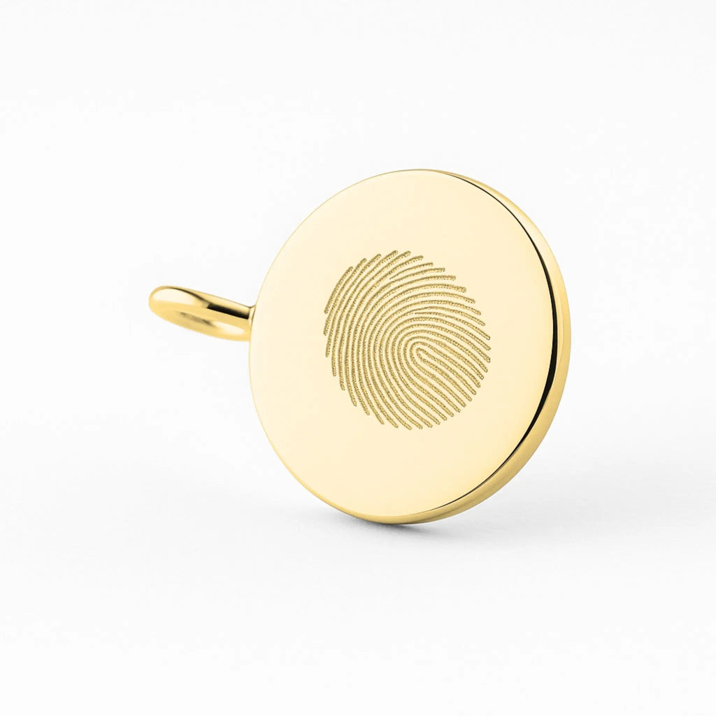 Close-up of Atelier By DSGN 18k gold vermeil single fingerprint coin necklace, showcasing intricate design and craftsmanship.