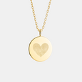The Heart Fingerprint Coin Necklace in 18K Gold Vermeil by Atelier, featuring two intricately engraved fingerprints forming a heart shape. A luxurious and meaningful piece of jewelry that celebrates love, unity, and connection - crafted from premium gold vermeil for timeless elegance and everyday wear.