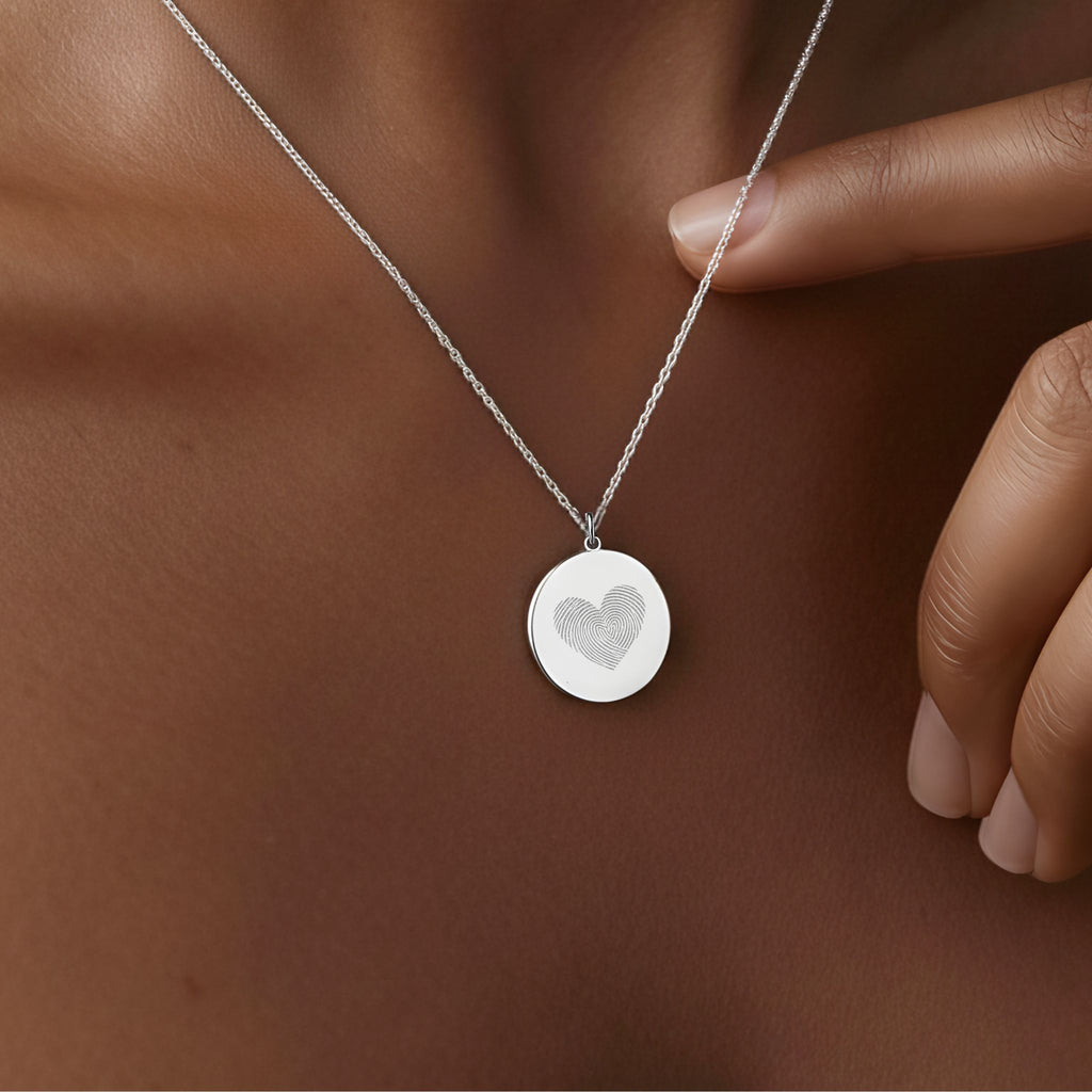 Heart Fingerprint Necklace by Atelier in 925 Sterling Silver worn on a model, showcasing a delicate heart-shaped fingerprint engraving that symbolises eternal love, memory, and connection.