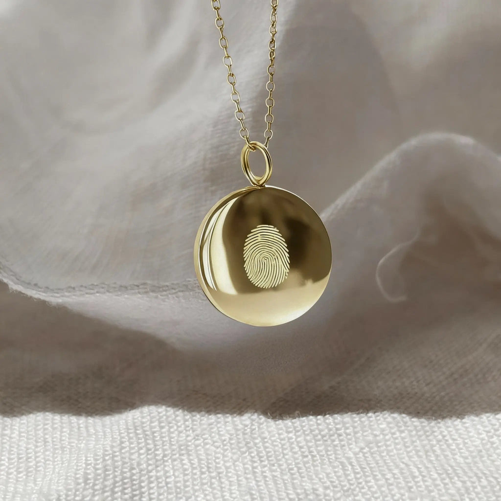 Minimalist single fingerprint coin necklace in 18k gold vermeil by Atelier By DSGN, showcasing a unique pendant design.