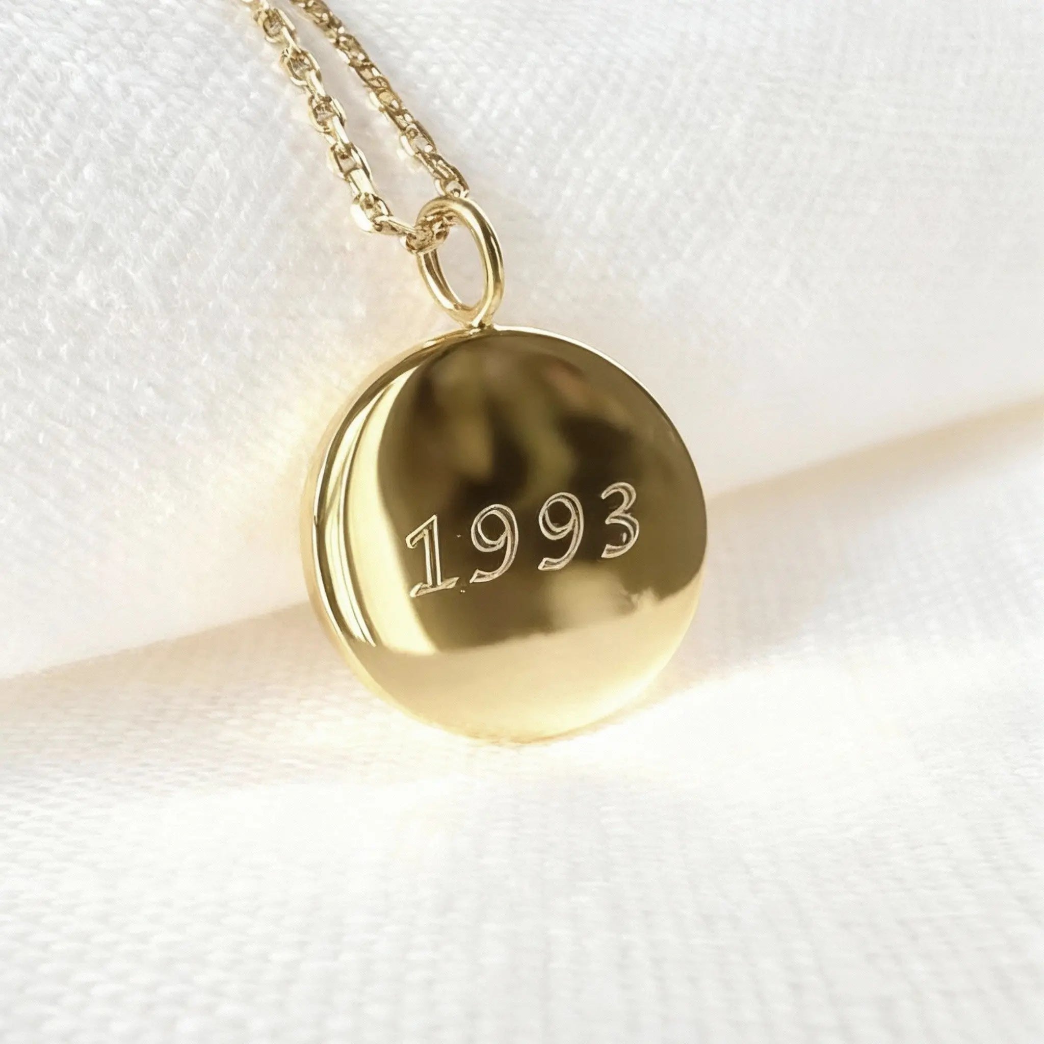 Personalized 18k gold vermeil fingerprint coin necklace by Atelier By DSGN with date engraving on the back.