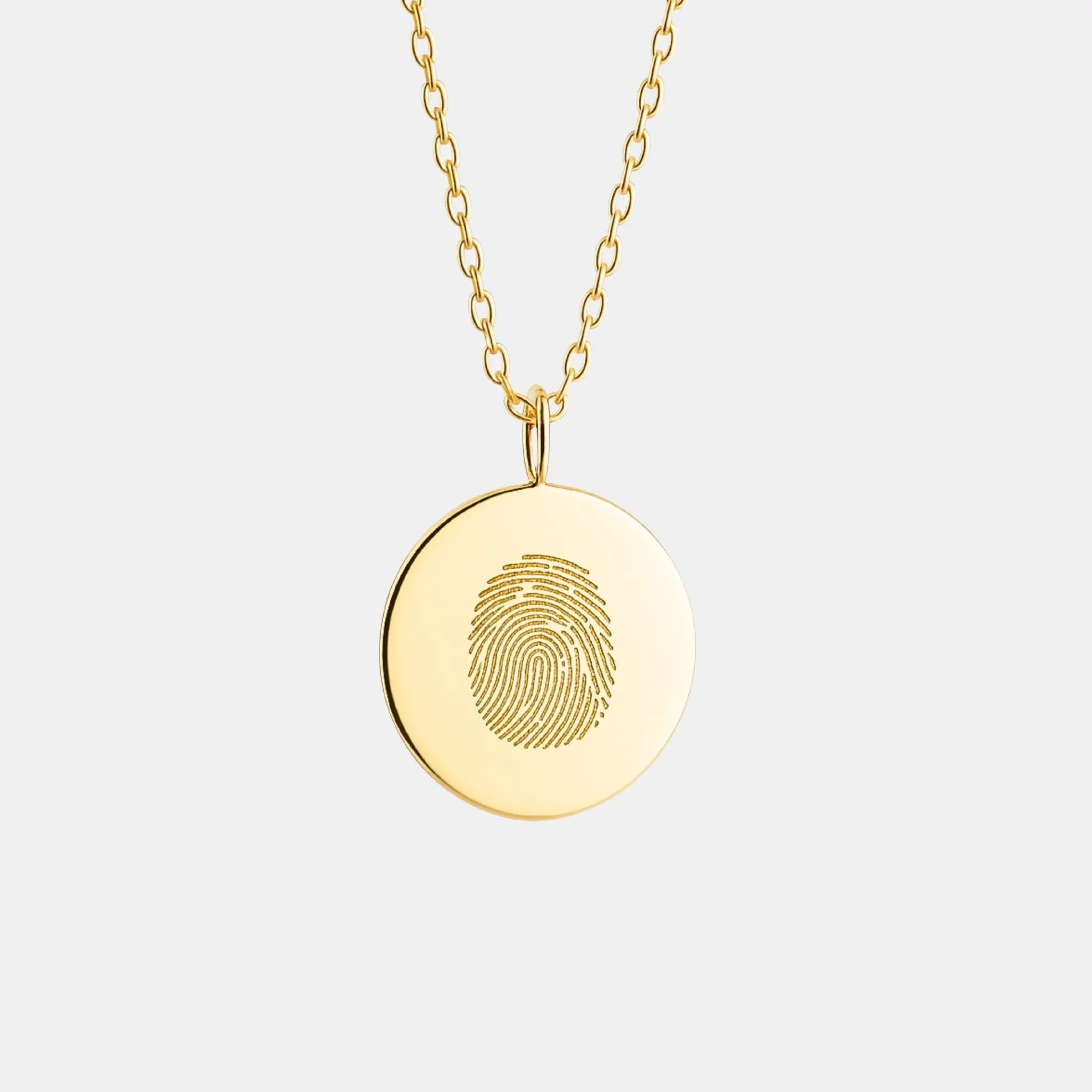 Single fingerprint coin necklace in 18k gold vermeil by Atelier By DSGN showcasing detailed fingerprint engraving.