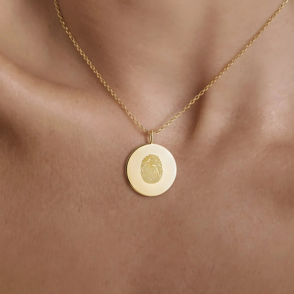 Single fingerprint coin necklace in 18k gold vermeil, worn on a neck, by Atelier By DSGN  luxury jewelry.