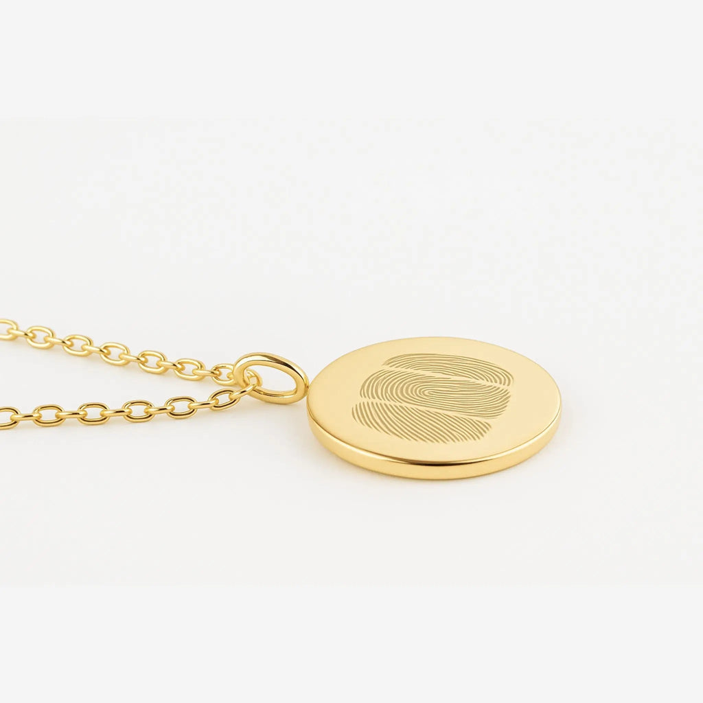 Luxury Three Fingerprint Coin Necklace in 18K Gold Vermeil by Atelier By DSGN, displayed on a soft white background. Features three precision-engraved fingerprints on a sleek gold pendant, representing love, connection, and craftsmanship. A timeless, custom piece designed for lasting elegance.