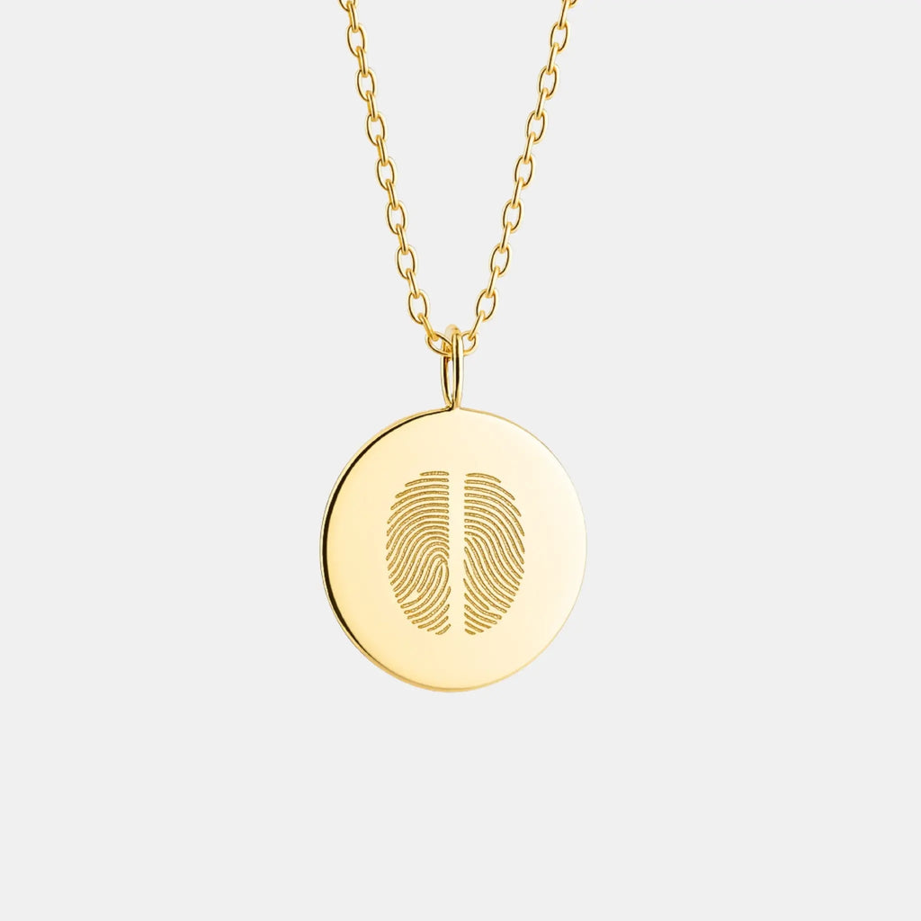 Two Fingerprint Coin Necklace in 18k Gold Vermeil by Atelier By DSGN luxury custom jewelry featuring dual engraved fingerprints on a polished round gold pendant.